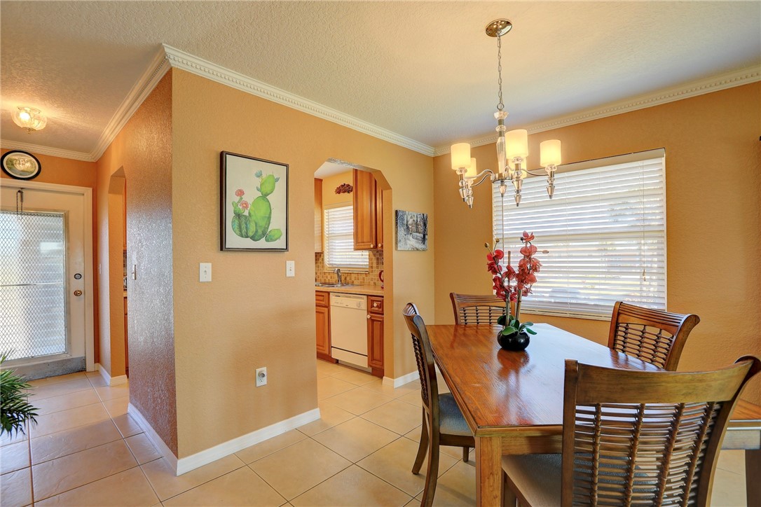 105 Spring Lake Court, Unit 207 Vero Beach, FL 32962 - Photo 7 of 34 a dining room with furniture and window