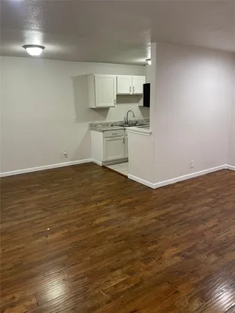 a view of a kitchen with wooden floor