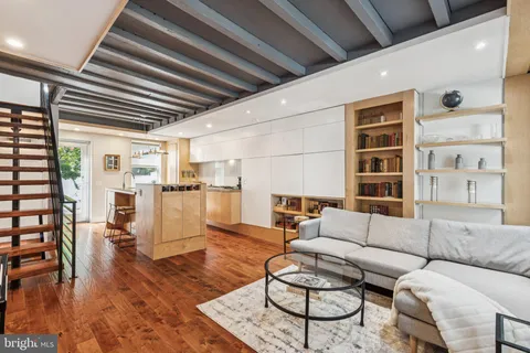 a living room with furniture and wooden floor
