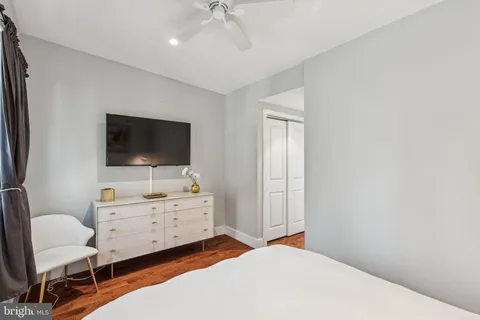 a bedroom with a bed and a flat screen tv