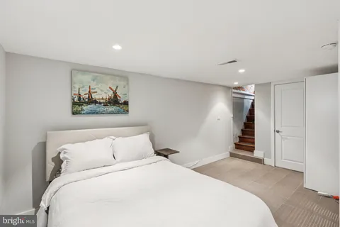 a bedroom with a large bed and a painting