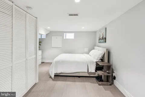 a bedroom with a bed and a chair