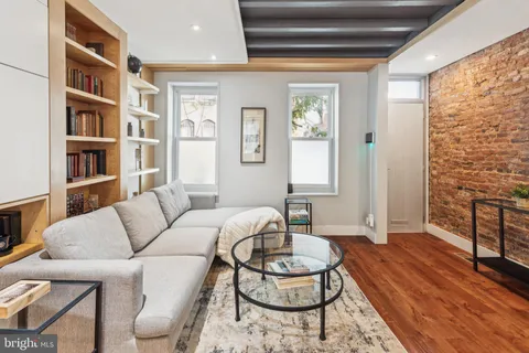 a living room with furniture a rug and a window