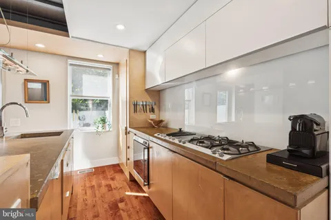 a kitchen with stainless steel appliances granite countertop a stove and a sink