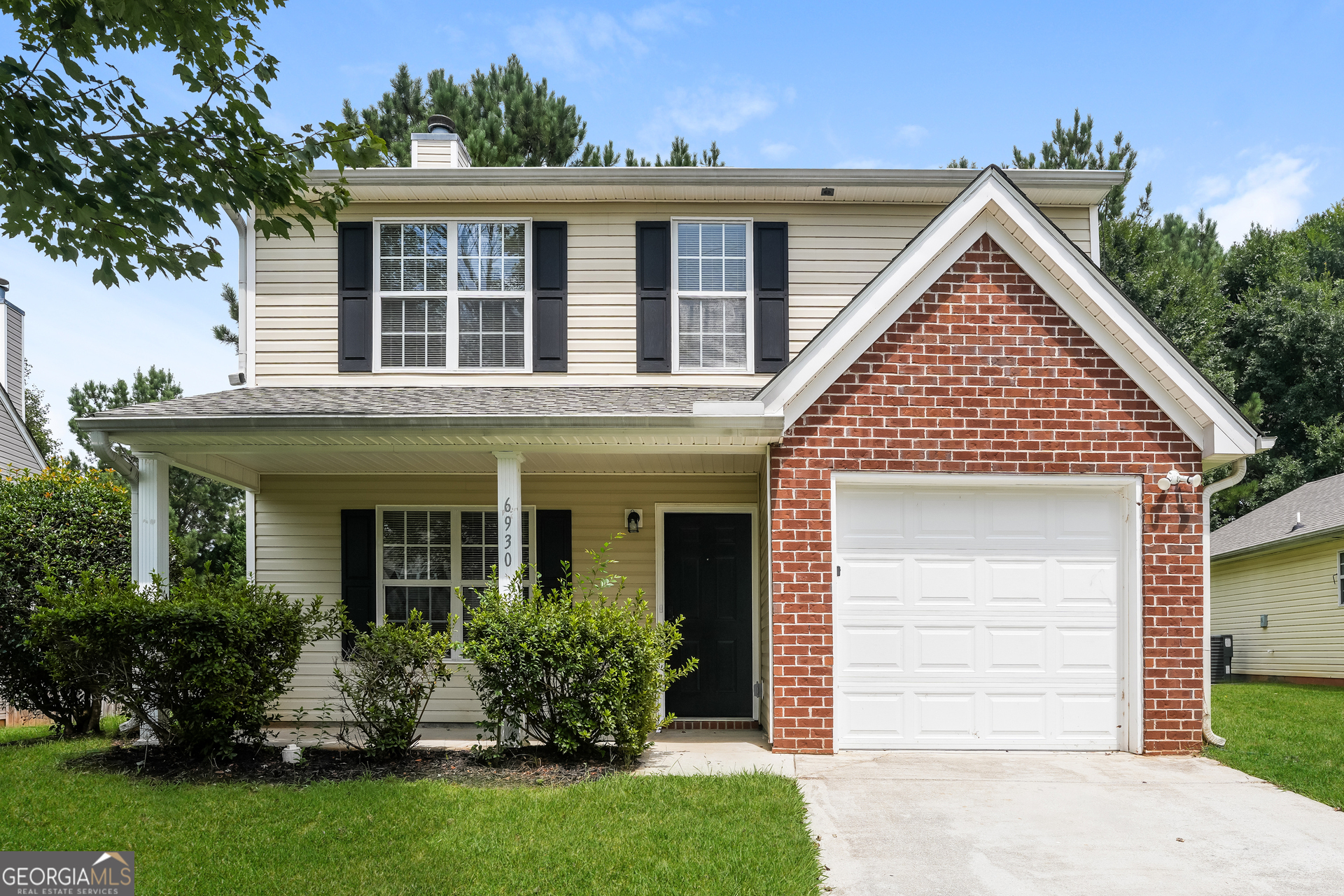 6930 Red Bone Way Lithonia, GA 30038 - Photo 1 of 17 a front view of a house with a garden and plants