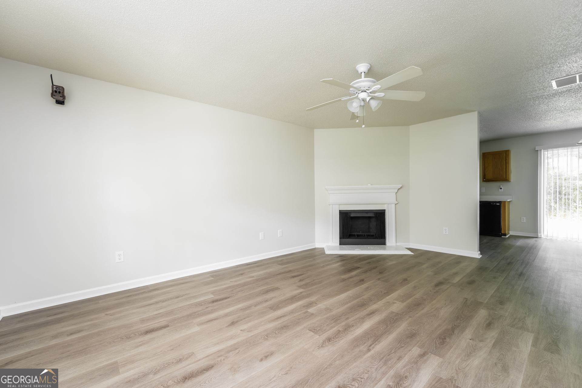 6930 Red Bone Way Lithonia, GA 30038 - Photo 2 of 17 a view of an empty room with wooden floor and a fireplace