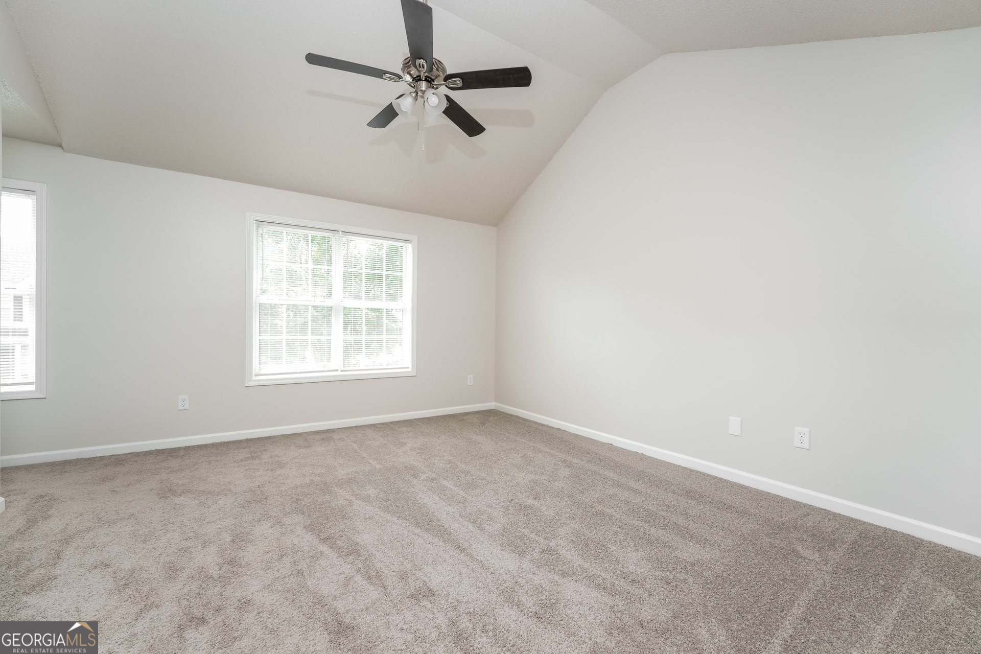 6930 Red Bone Way Lithonia, GA 30038 - Photo 7 of 17 an empty room with windows and fan