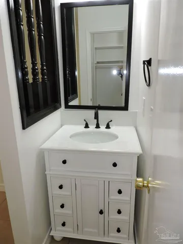 a bathroom with a sink vanity and mirror