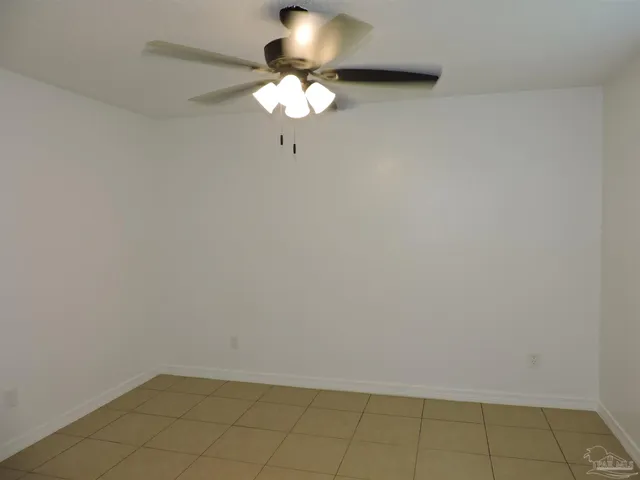 a view of a small space with wooden floor and a chandelier