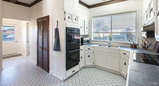 a kitchen with stainless steel appliances a refrigerator sink and cabinets