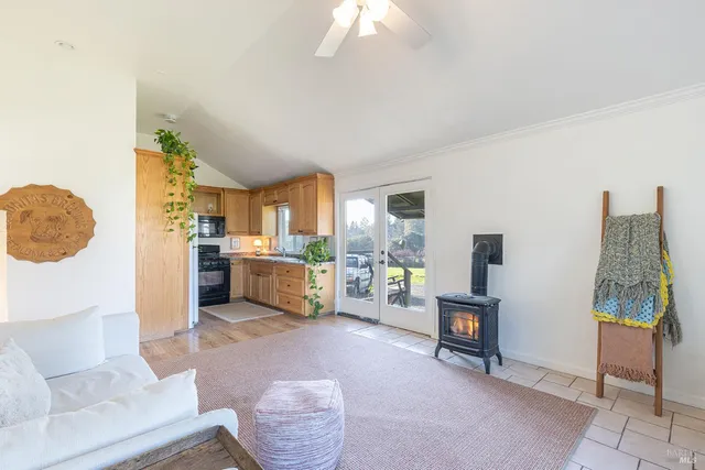 a living room with furniture and a kitchen