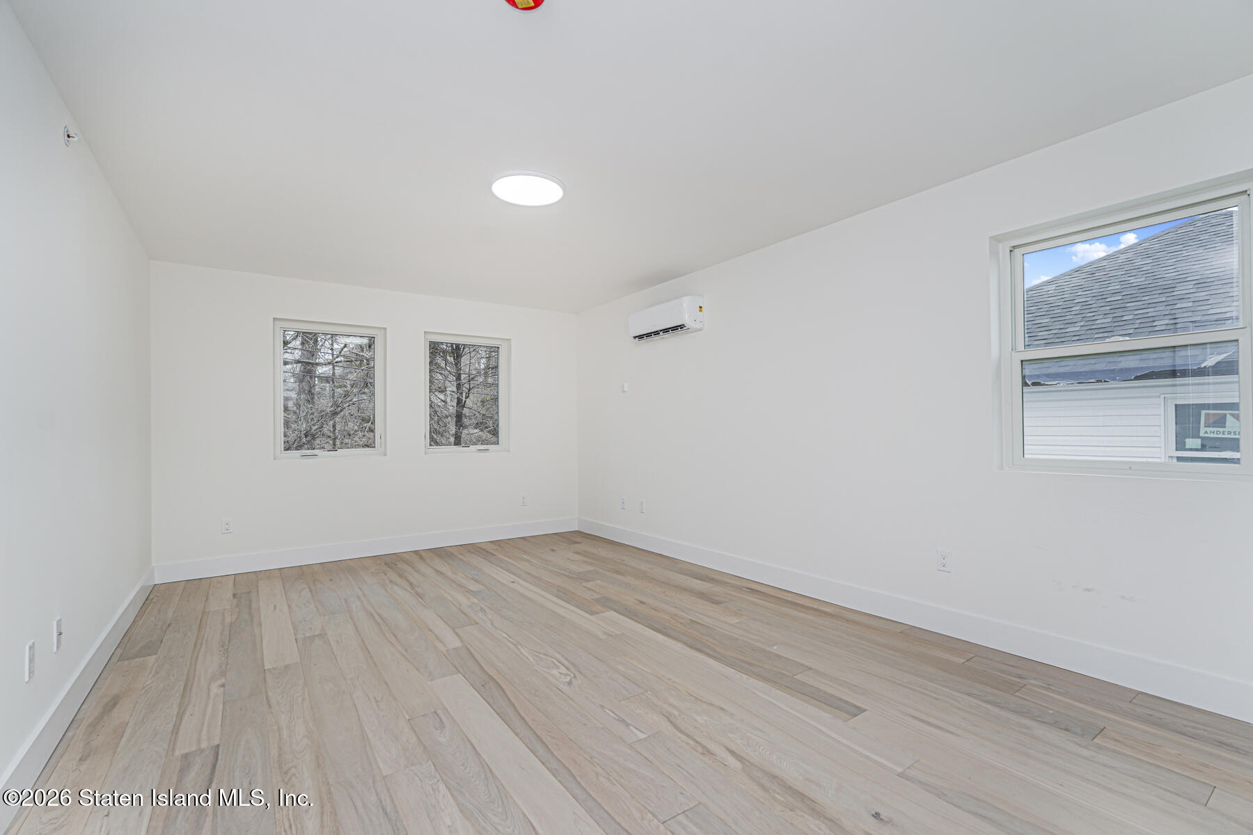 54 Cedarcliff Road Staten Island, NY 10301 - Photo 33 of 49 an empty room with wooden floor and windows