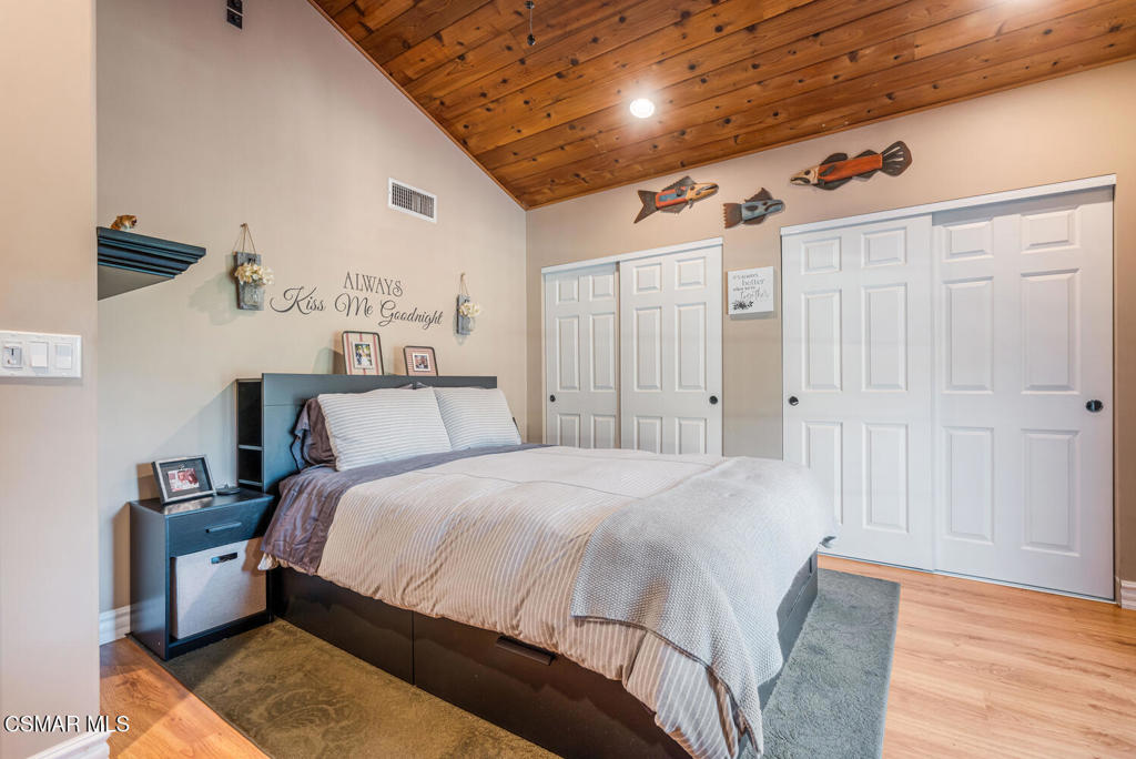 1088 Alta Vista Road Simi Valley, CA 93063 - Photo 18 of 24 a large bed sitting in a bedroom next to a cabinet