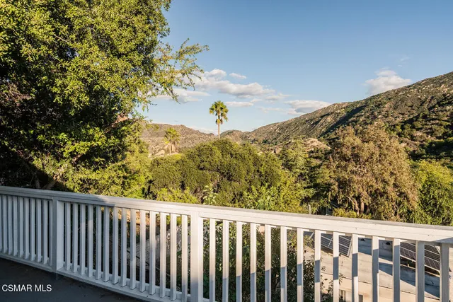 a view of a balcony with wooden fence