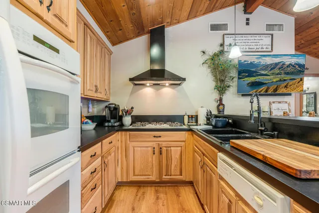 a kitchen with stainless steel appliances granite countertop a sink and cabinets