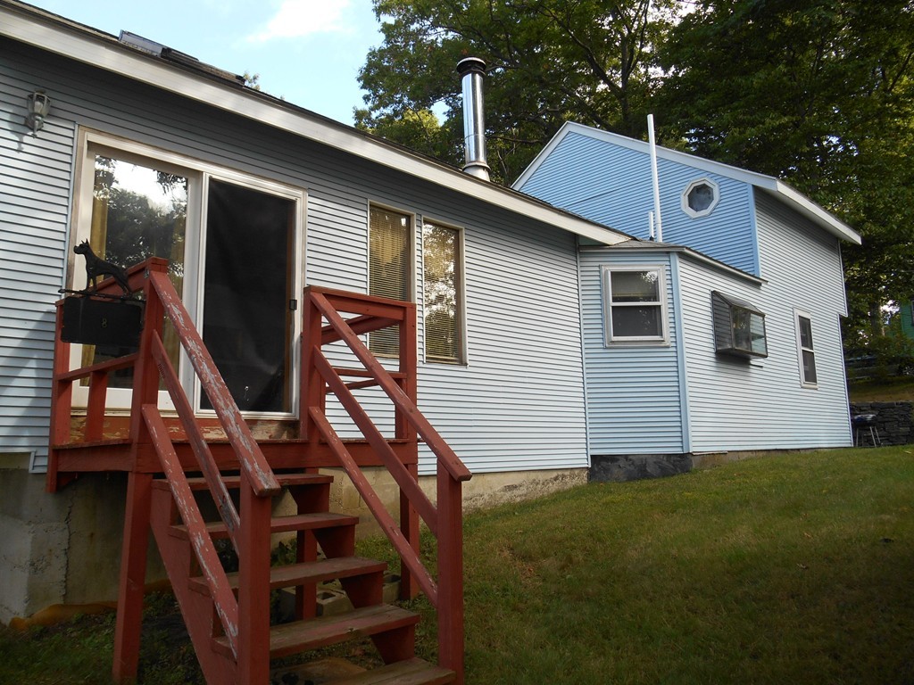 8 Victoria Avenue Rutland, MA 01543 - Photo 3 of 30 a front view of house with yard and trees in the background