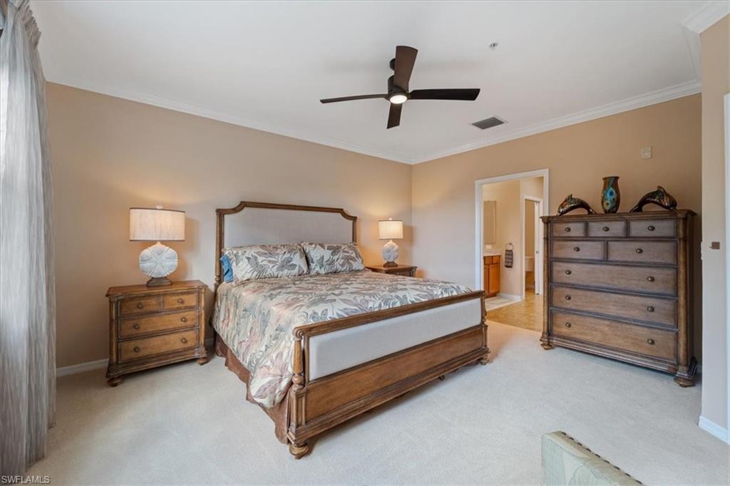 14981 Reflection Key Circle, Unit 322 Fort Myers, FL 33907 - Photo 10 of 35 a bedroom with a bed and a ceiling fan