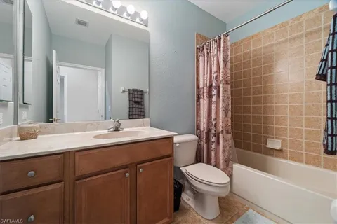 a bathroom with a double vanity sink a mirror and a shower
