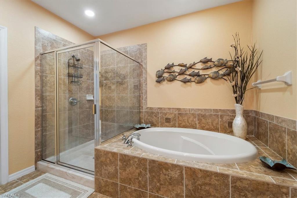 14981 Reflection Key Circle, Unit 322 Fort Myers, FL 33907 - Photo 13 of 35 a bathroom with a bathtub and shower
