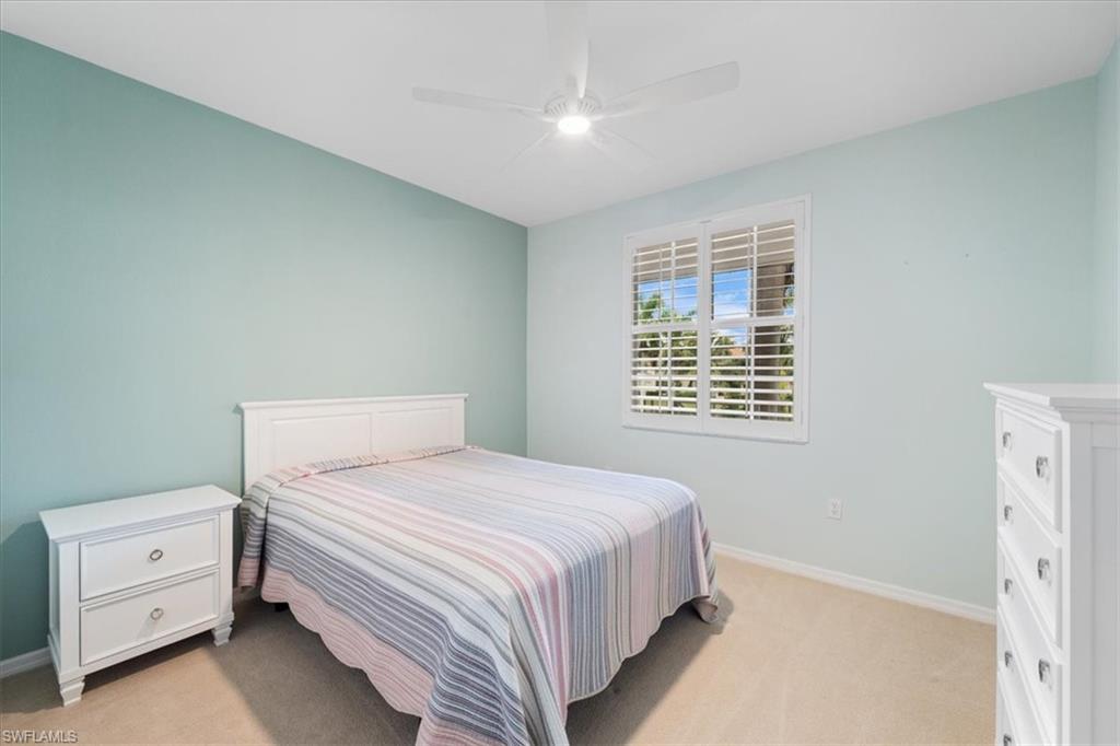 14981 Reflection Key Circle, Unit 322 Fort Myers, FL 33907 - Photo 15 of 35 a bedroom with a bed and a window