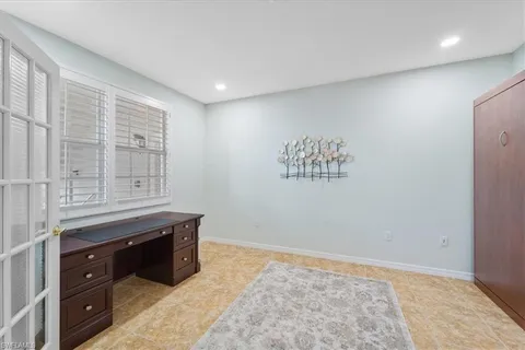 a view of kitchen with granite countertop cabinets and window