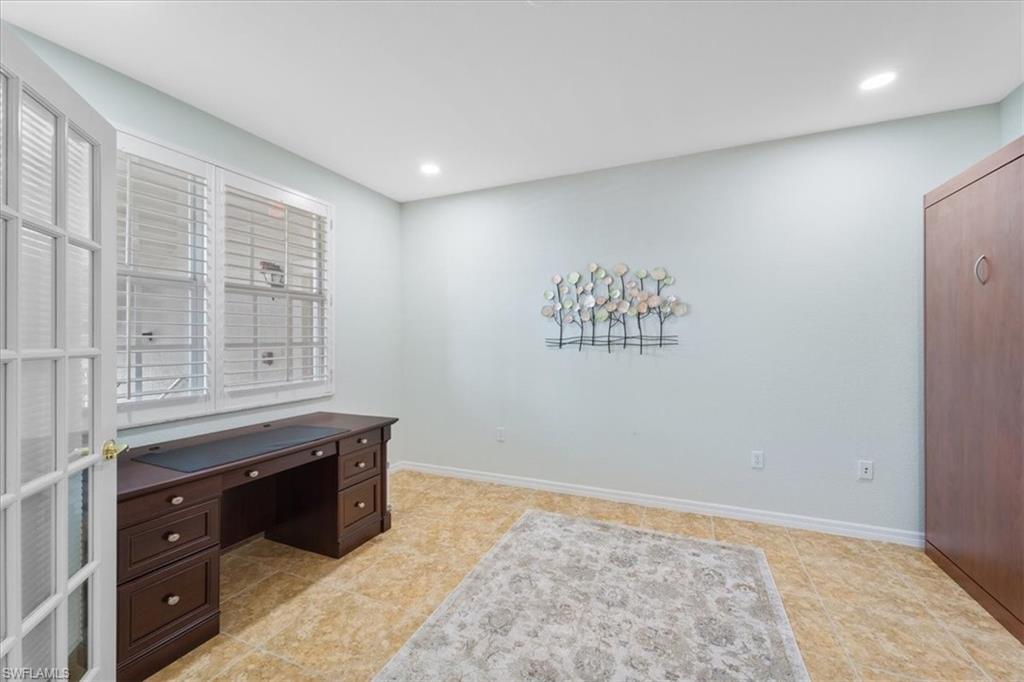 14981 Reflection Key Circle, Unit 322 Fort Myers, FL 33907 - Photo 18 of 35 a view of kitchen with granite countertop cabinets and window