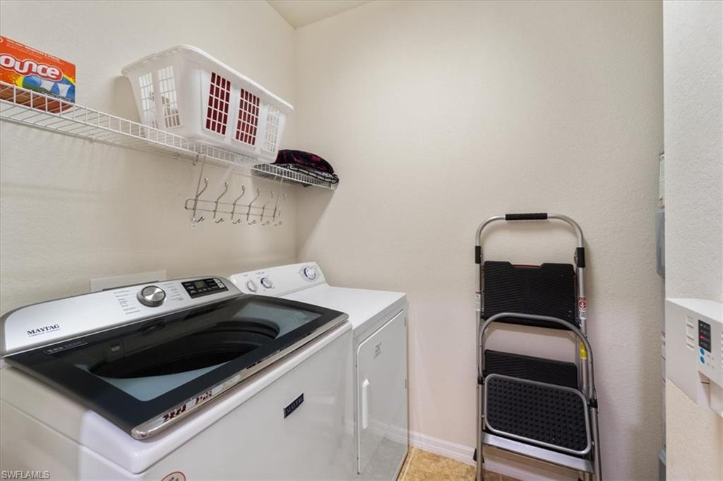 14981 Reflection Key Circle, Unit 322 Fort Myers, FL 33907 - Photo 22 of 35 a utility room with dryer and washer