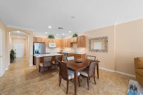 a kitchen with stainless steel appliances granite countertop a stove refrigerator sink and cabinets