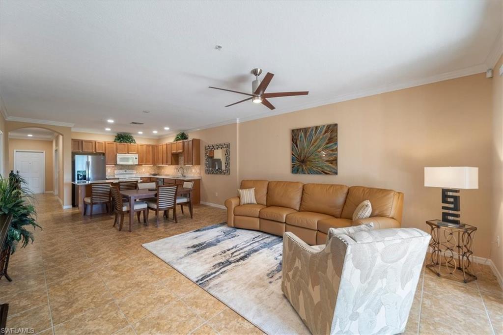 14981 Reflection Key Circle, Unit 322 Fort Myers, FL 33907 - Photo 28 of 35 a living room with furniture and a dining table with kitchen view