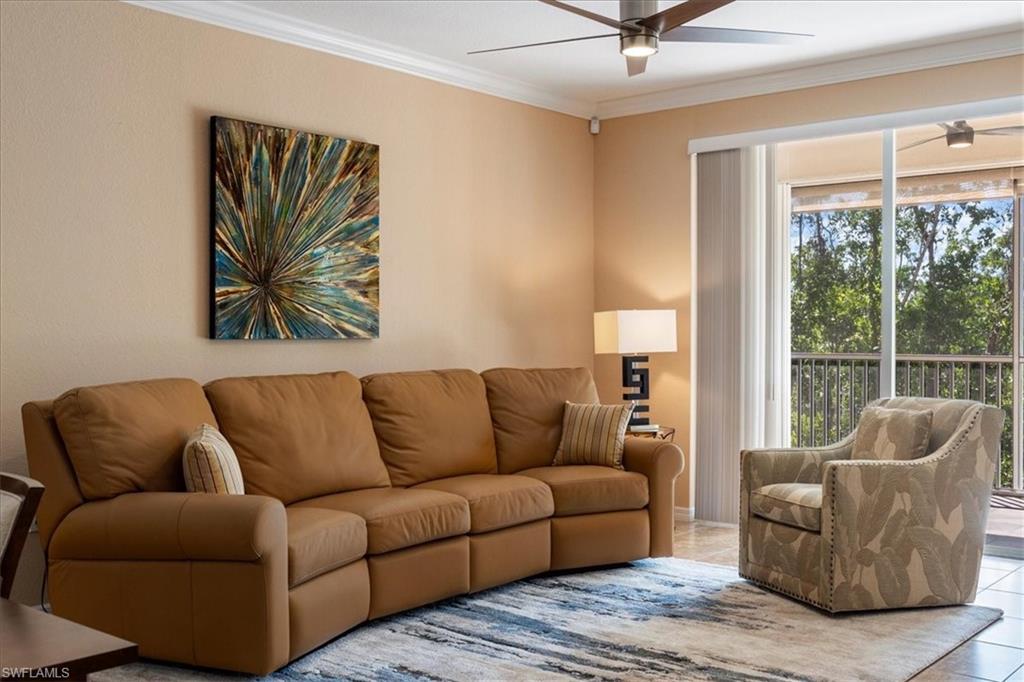 14981 Reflection Key Circle, Unit 322 Fort Myers, FL 33907 - Photo 29 of 35 a living room with furniture and a large window