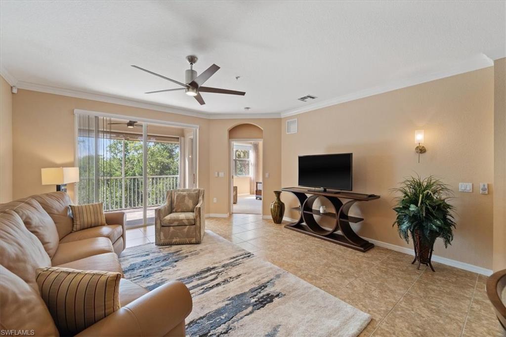 14981 Reflection Key Circle, Unit 322 Fort Myers, FL 33907 - Photo 3 of 35 a living room with furniture a flat screen tv and a large window