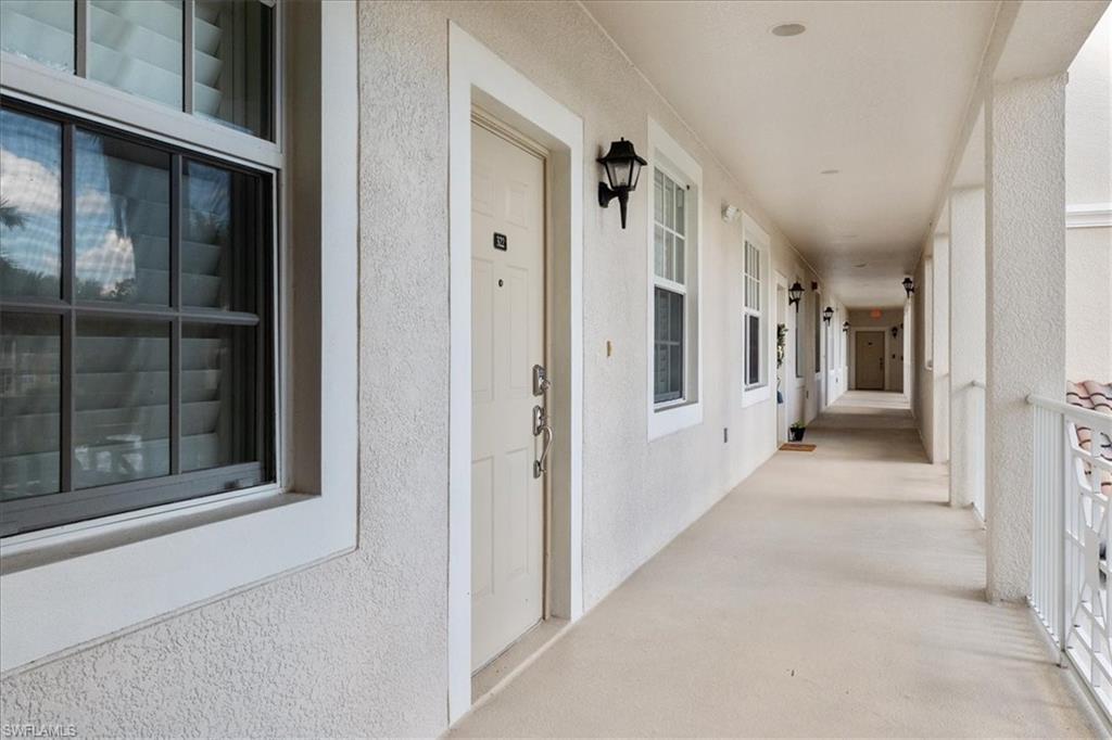 14981 Reflection Key Circle, Unit 322 Fort Myers, FL 33907 - Photo 33 of 35 a view of a hallway with a wooden door