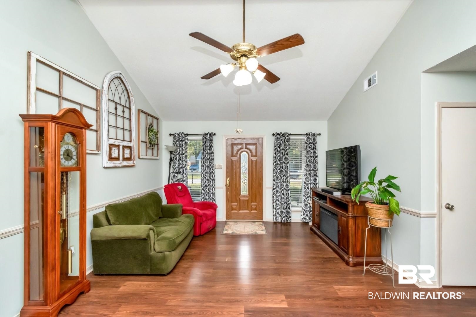 9360 Burnt Tree Drive Mobile, AL 36695 - Photo 6 of 28 Living room featuring ceiling fan, dark wood-type flooring, and vaulted ceiling