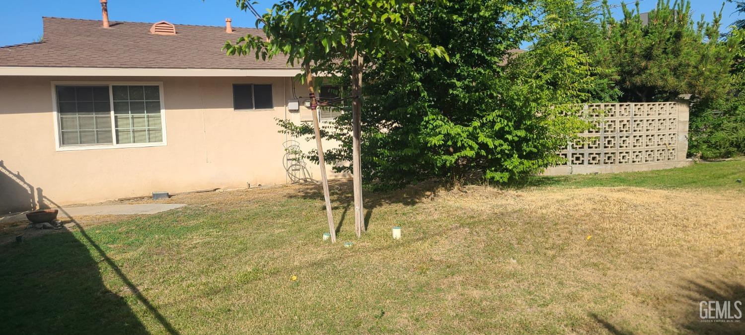 Undisclosed Address Bakersfield, CA 93309 - Photo 16 of 18 a view of a house with backyard and a tree