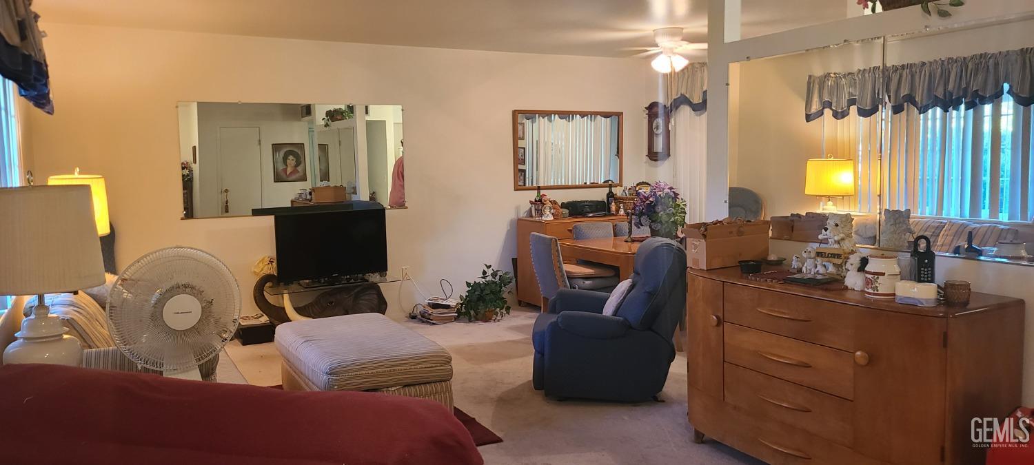 Undisclosed Address Bakersfield, CA 93309 - Photo 5 of 18 a living room with furniture a large window and dresser
