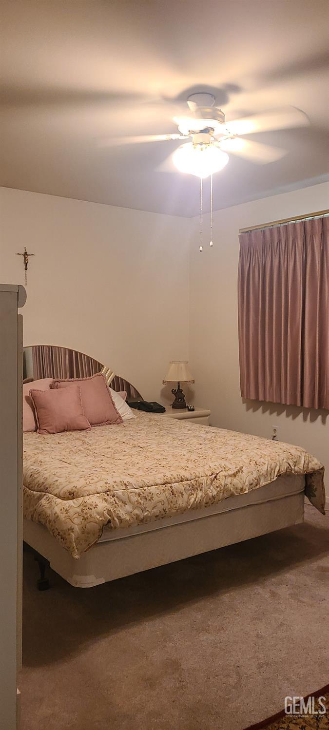 Undisclosed Address Bakersfield, CA 93309 - Photo 9 of 18 a bedroom with a bed and a lamp