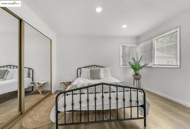 a bedroom with a bed table and a window