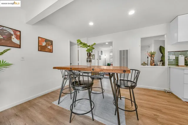 a dining room with furniture and wooden floor