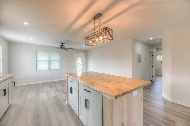 wooden floor in an empty room with a bathroom