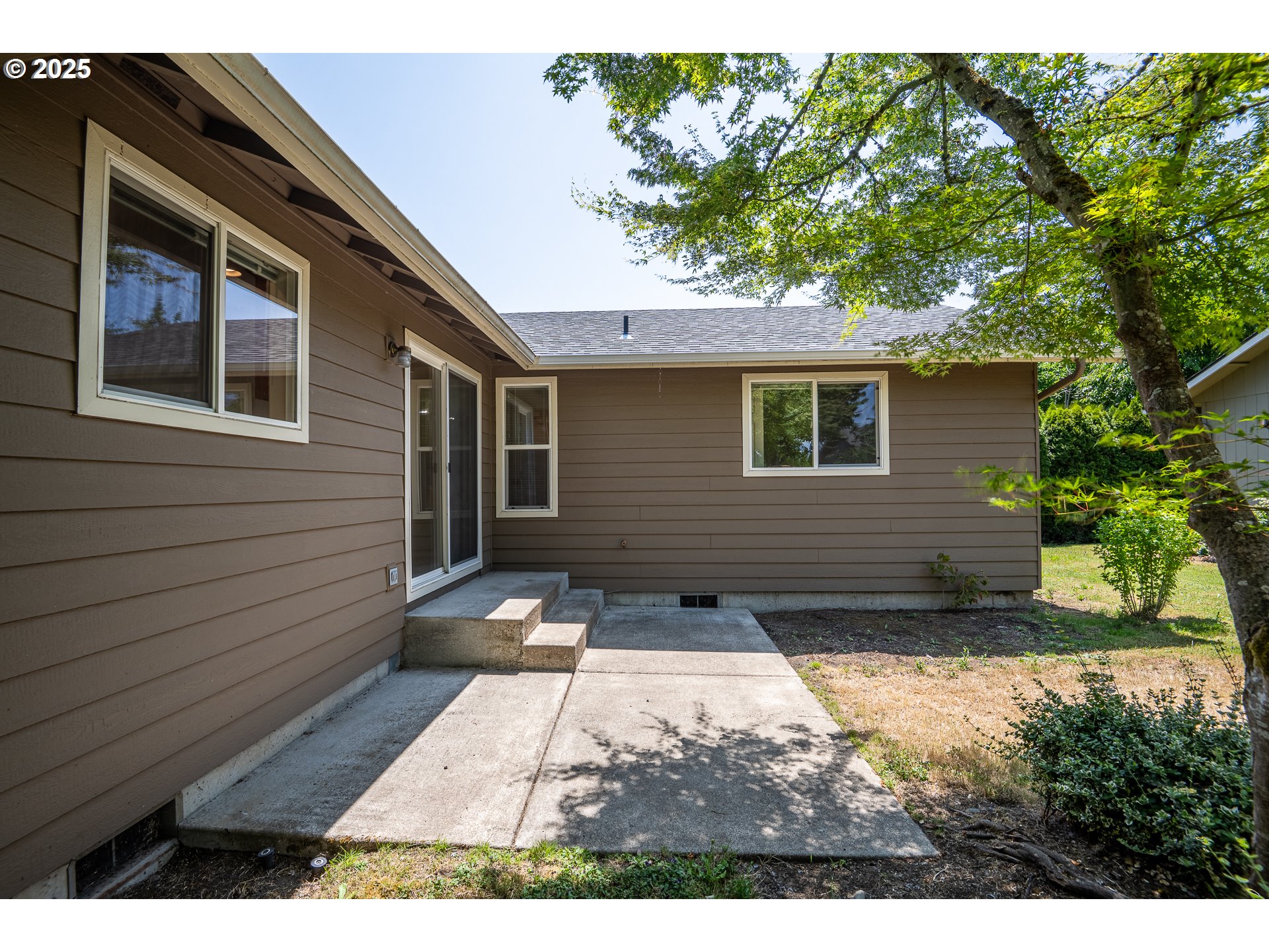 576 South 35th Street Springfield, OR 97478 - Photo 26 of 34 a view of backyard with a large tree and wooden fence