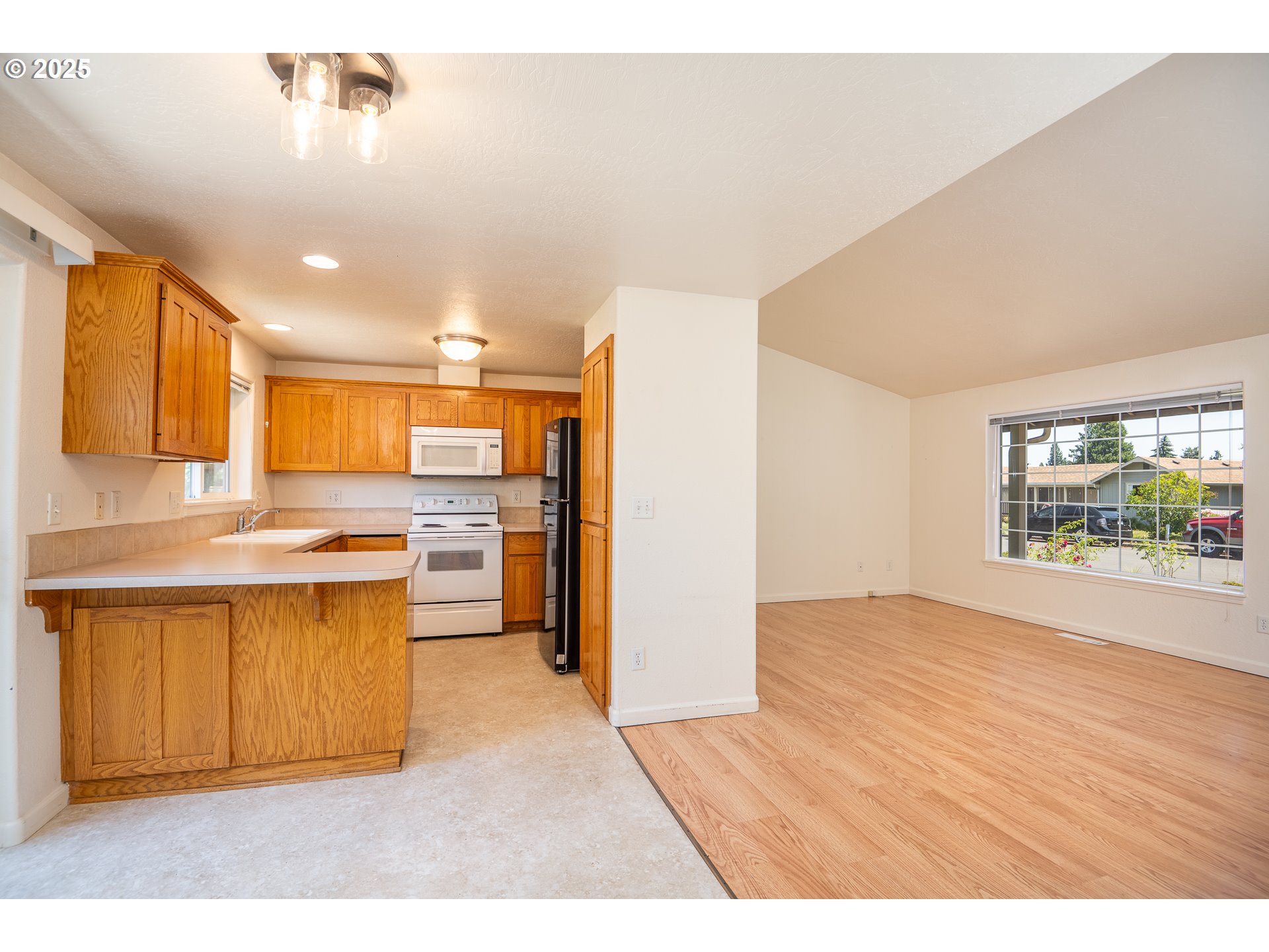 576 South 35th Street Springfield, OR 97478 - Photo 6 of 34 a open kitchen with stainless steel appliances granite countertop a refrigerator a sink dishwasher a stove and a view of living room