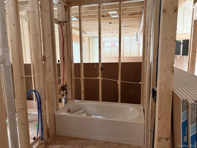 a bathroom with a bathtub next to a window