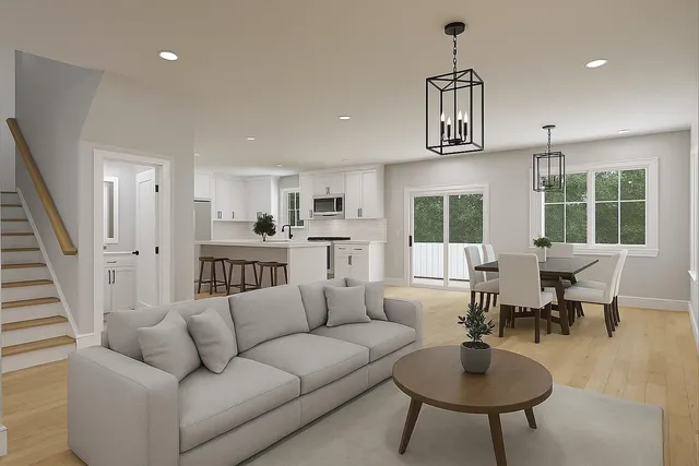 a living room with furniture kitchen view and a window