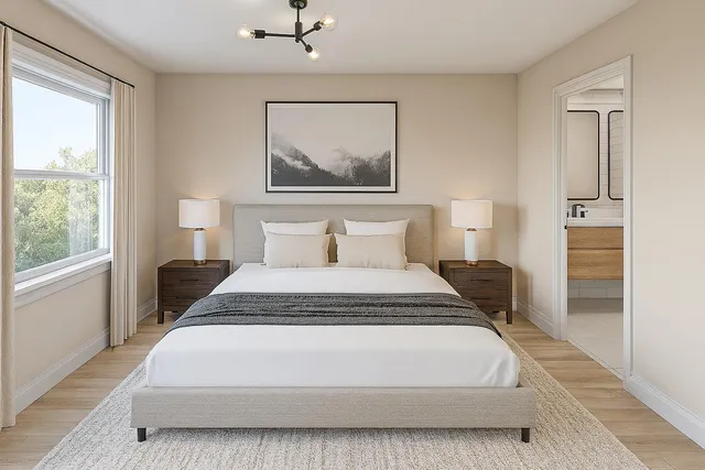 a bedroom with a bed and a painting on the wall