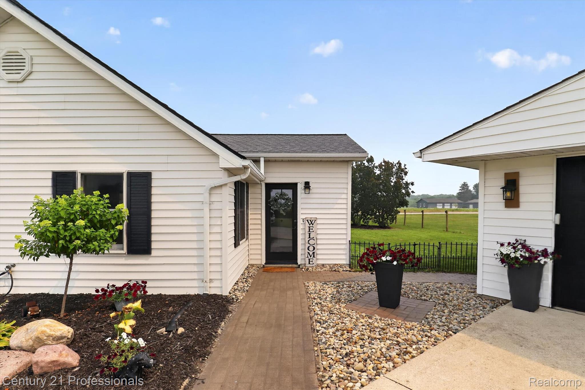 13525 Dennison Road Milan, MI 48160 - Photo 65 of 69 White siding exterior with black window shutters and a black front door
