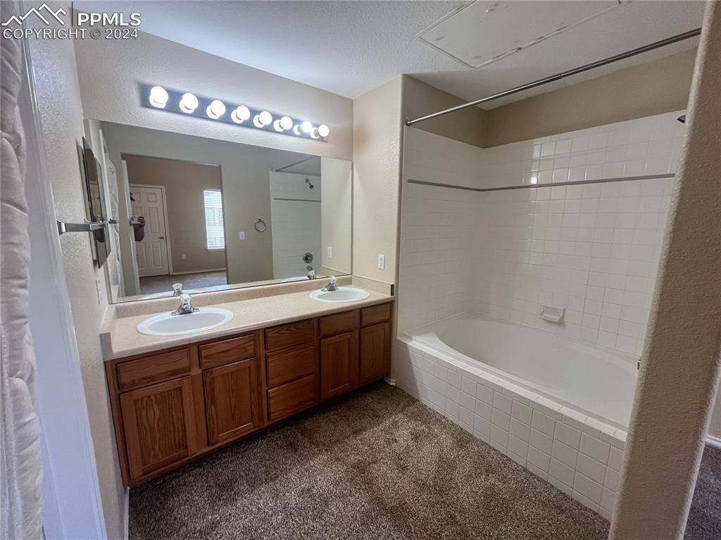 3731 Riviera Grove, Unit 203 Colorado Springs, CO 80922 - Photo 20 of 22 a spacious bathroom with a tub sink and mirror