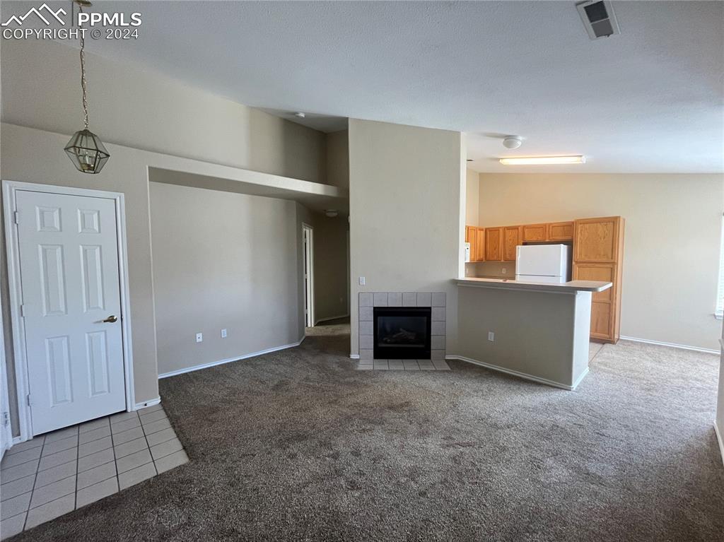 3731 Riviera Grove, Unit 203 Colorado Springs, CO 80922 - Photo 7 of 22 an empty room with windows and cabinet