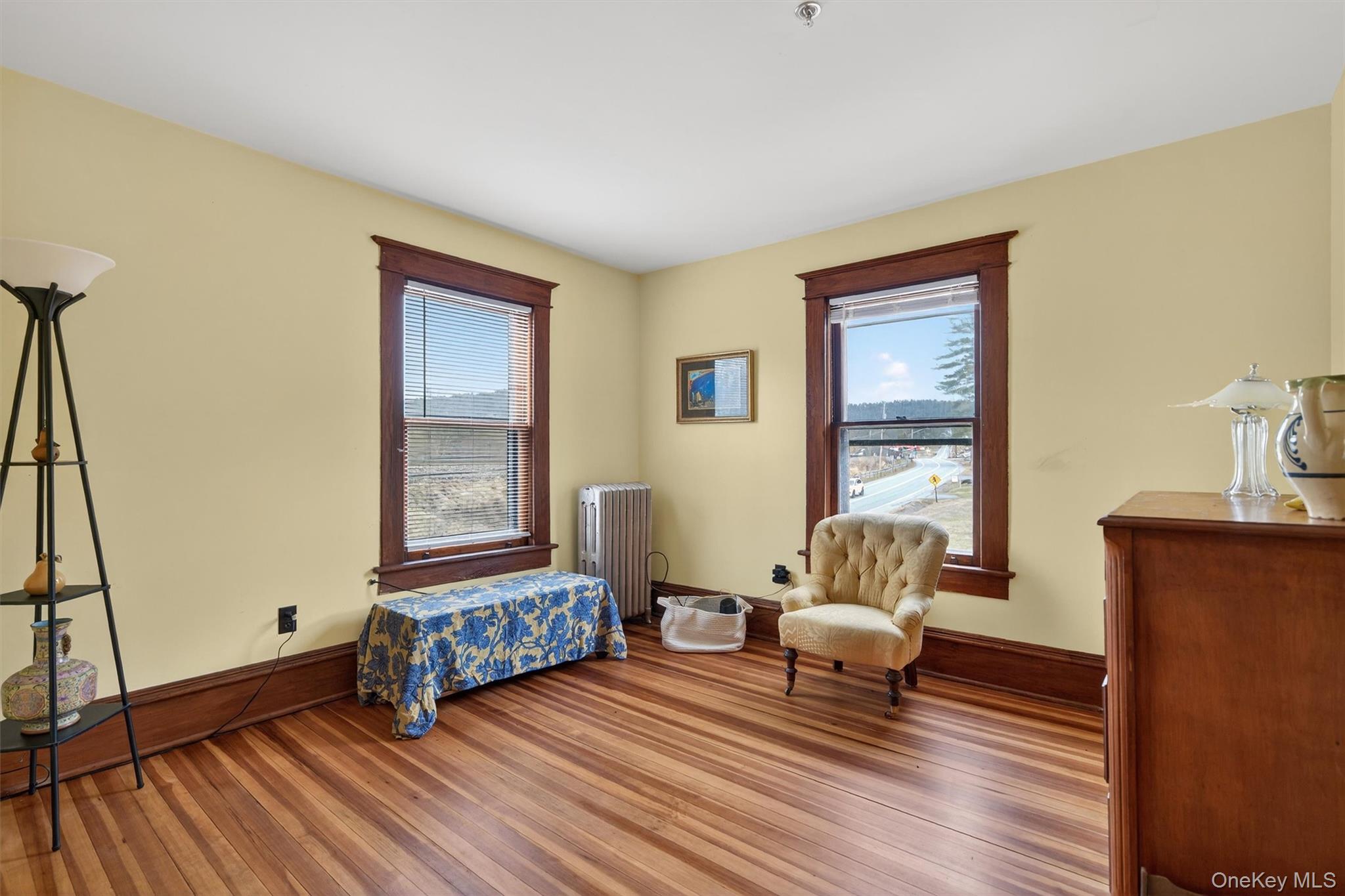 48 Kirks Road Narrowsburg, NY 12764 - Photo 29 of 50 Bedroom featuring radiator, wood finished floors, and multiple windows