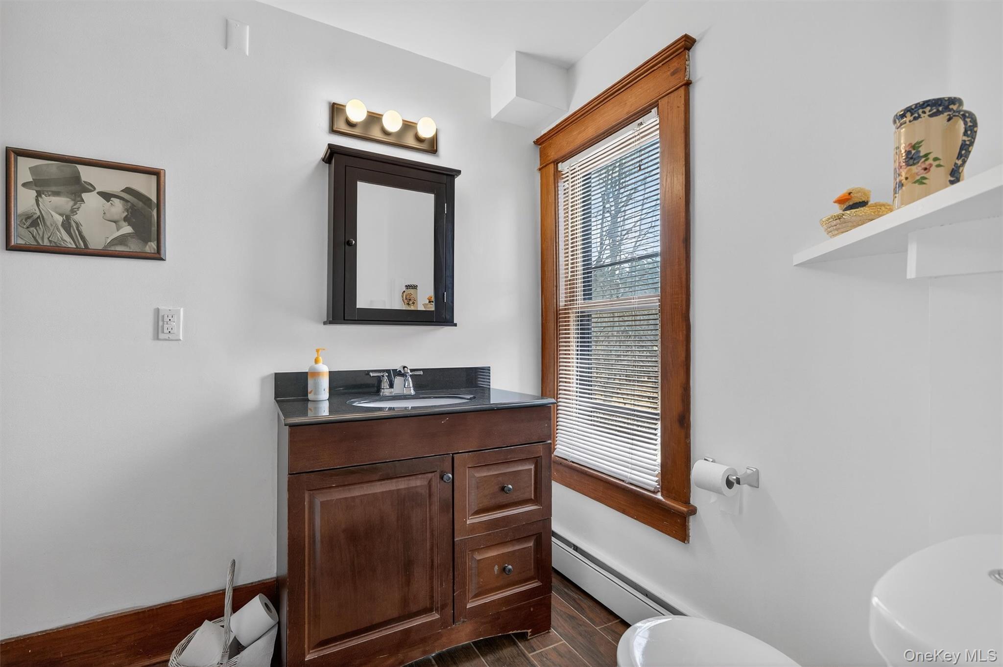 48 Kirks Road Narrowsburg, NY 12764 - Photo 33 of 50 Bathroom with vanity, baseboard heating, and wood finish floors
