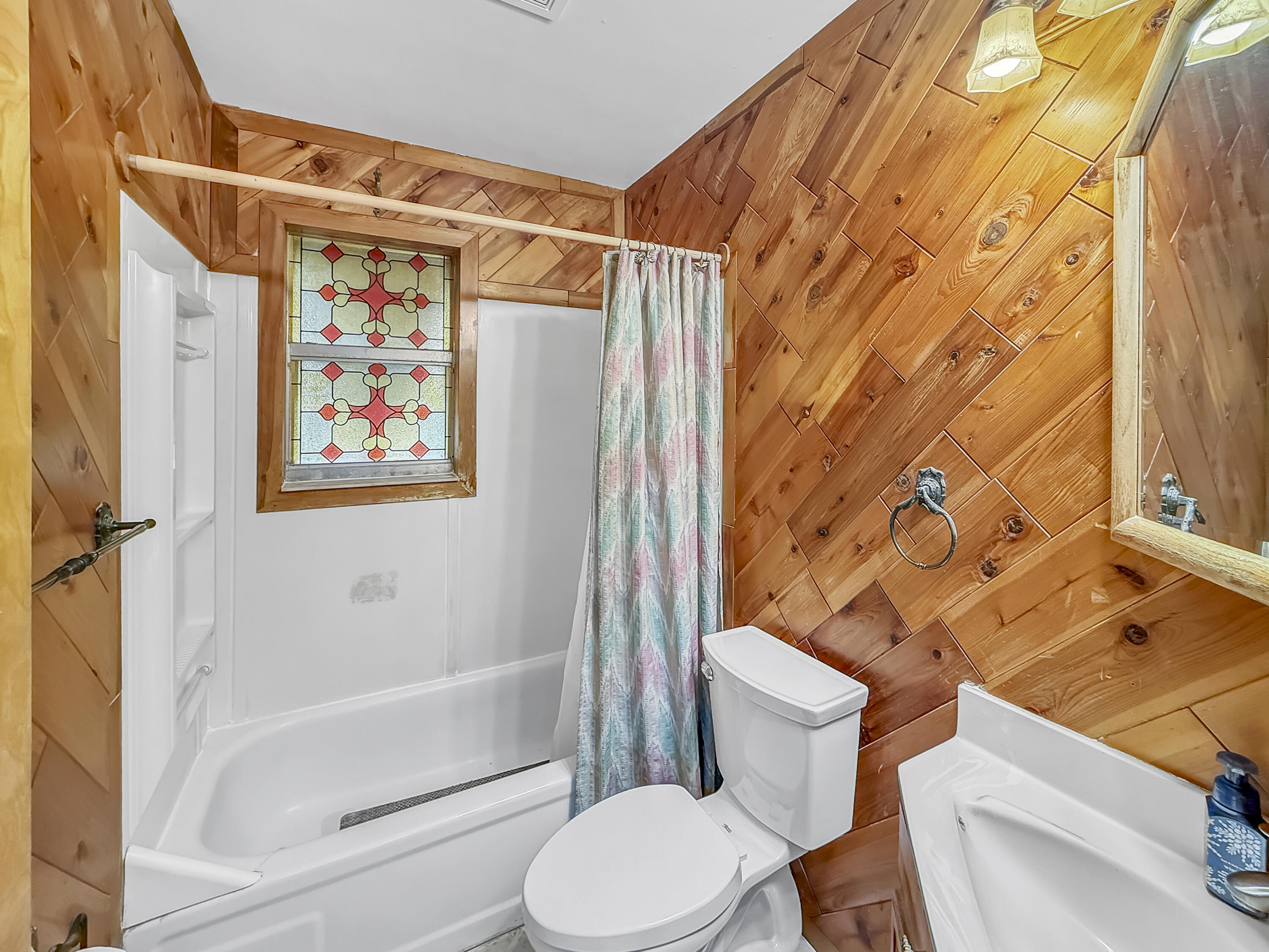 4387 Appian Way Greenacres, FL 33463 - Photo 11 of 14 a bathroom with a toilet and a shower curtain